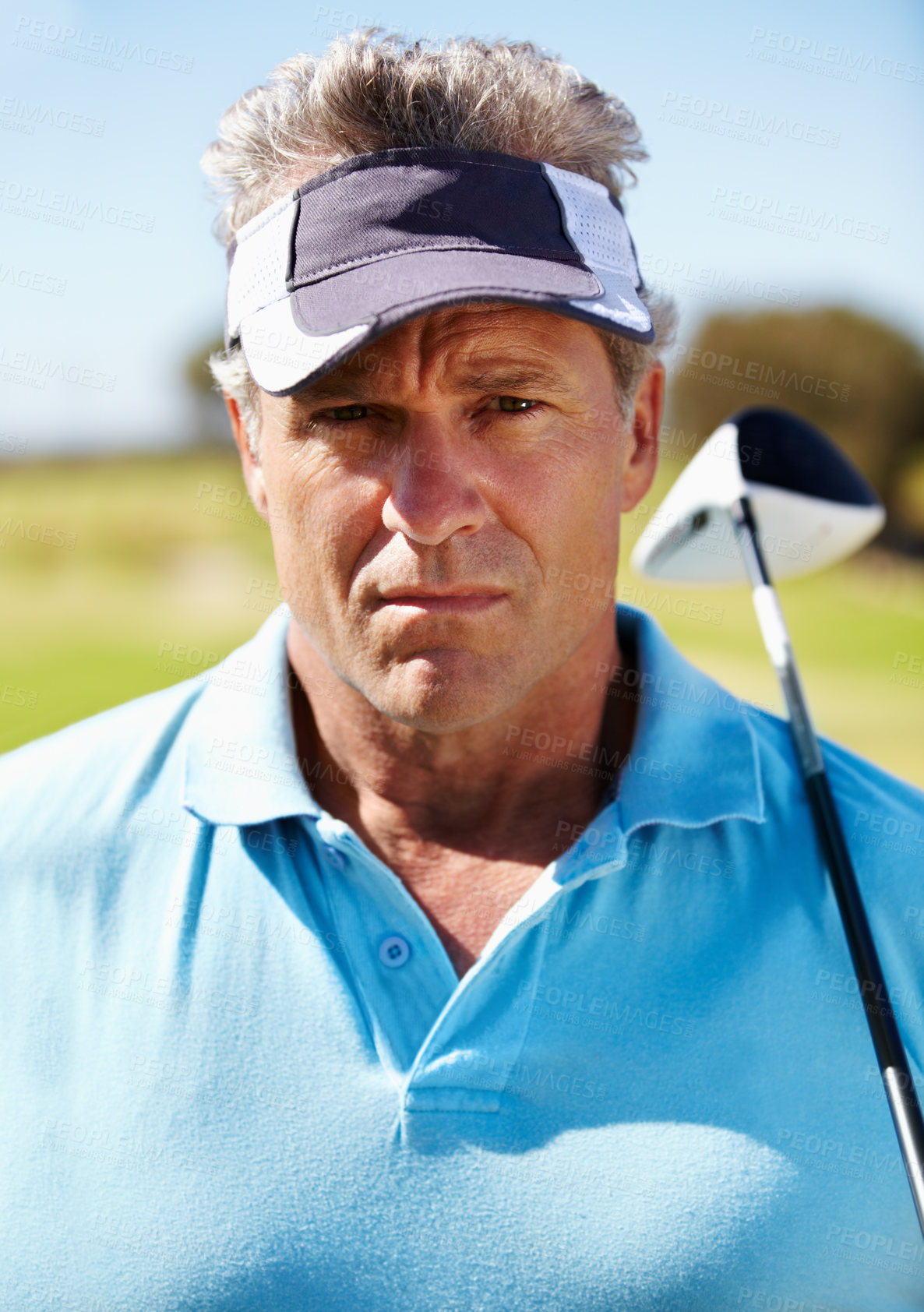 Buy stock photo Head and shoulders portrait of a mature golfer with his club over his shoulder