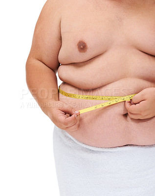Buy stock photo Overweight, tape measure and man checking diet progress and weight loss goal in studio. White background, hands and model with plus size stomach with body problem and health issue with towel 