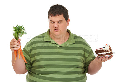 Buy stock photo Plus size, diet decision and angry man with a carrot and cake choice thinking about balance. Upset male model, studio and white background with healthy and dessert feeling hungry and frustrated