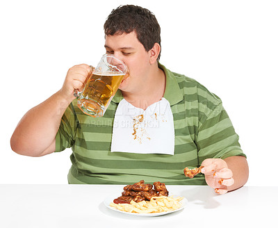 Buy stock photo Obesity, man and fast food with alcohol, unhealthy and guy isolated against a white studio background. Obese, male person and model with beer, chicken wings and eating with a bib, fries and hungry