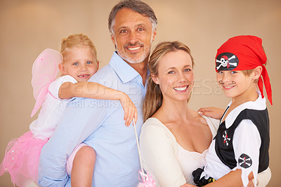Buy stock photo Happy family, portrait and halloween party in home, face paint and happiness in childhood. Man, woman and kids with house event clothes for birthday, love care and celebration together with wellness