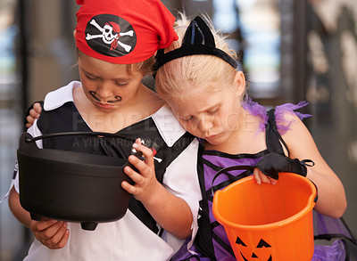Buy stock photo A brother and sister sulk together and look at their empty sweet baskets on halloween