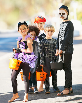 Buy stock photo Children, halloween or trick and treat portrait outdoor in neighborhood for fun and dress up. A group of young kids together for happiness, celebrate holiday and diversity with candy or sweets