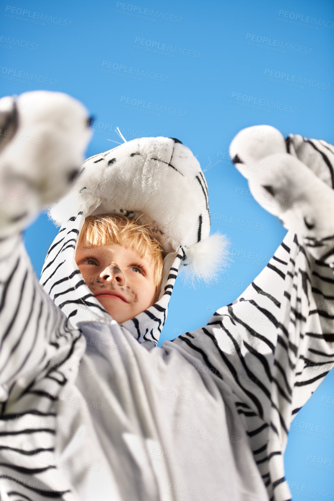 Buy stock photo Happy, boy and kid with tiger costume, smile and cheerful with joy, Halloween and outdoor on sky background. Child, outside and person with animal outfit, excited and playing with fun and fantasy