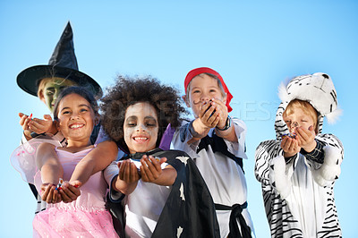Buy stock photo Children, group and hands in halloween costume for sweet candy asking, trick or treat for fantasy. Friends, smile and dress up as witch or pirate for holiday fun, kid development on sky background