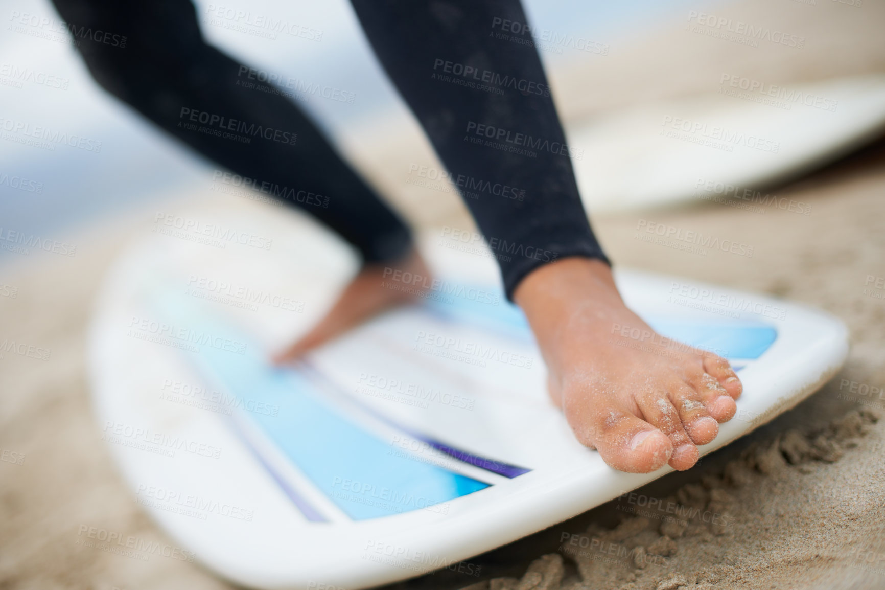 Buy stock photo Cropped shot of an unrecognizable female surfer's feet on a surfboard