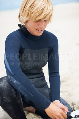 Buy stock photo Fitness, sports and a surfer getting ready on the beach for leisure, recreation or a summer hobby. Exercise, surfing or training with a happy young athlete on the sand at the start of his workout