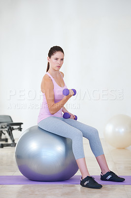 Buy stock photo Woman, fitness and exercise ball with dumbbells, balance or gym for training, strong muscle or arms. Girl, workout and vision with biceps, weightlifting and hard work for health, wellness and body