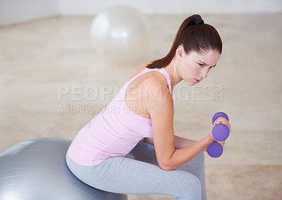 Buy stock photo Dumbbells, woman and fitness with workout, health and wellness studio with gym equipment, sports and exercise ball. Person, challenge and girl with progress, hardcore and endurance with energy