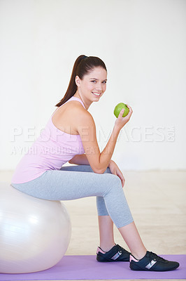 Buy stock photo Woman, apple and exercise ball for fitness, health and smile in portrait, workout and diet at gym. Female person, face and fruit for vitamins, nutrition and cardio for wellness, organic and happy