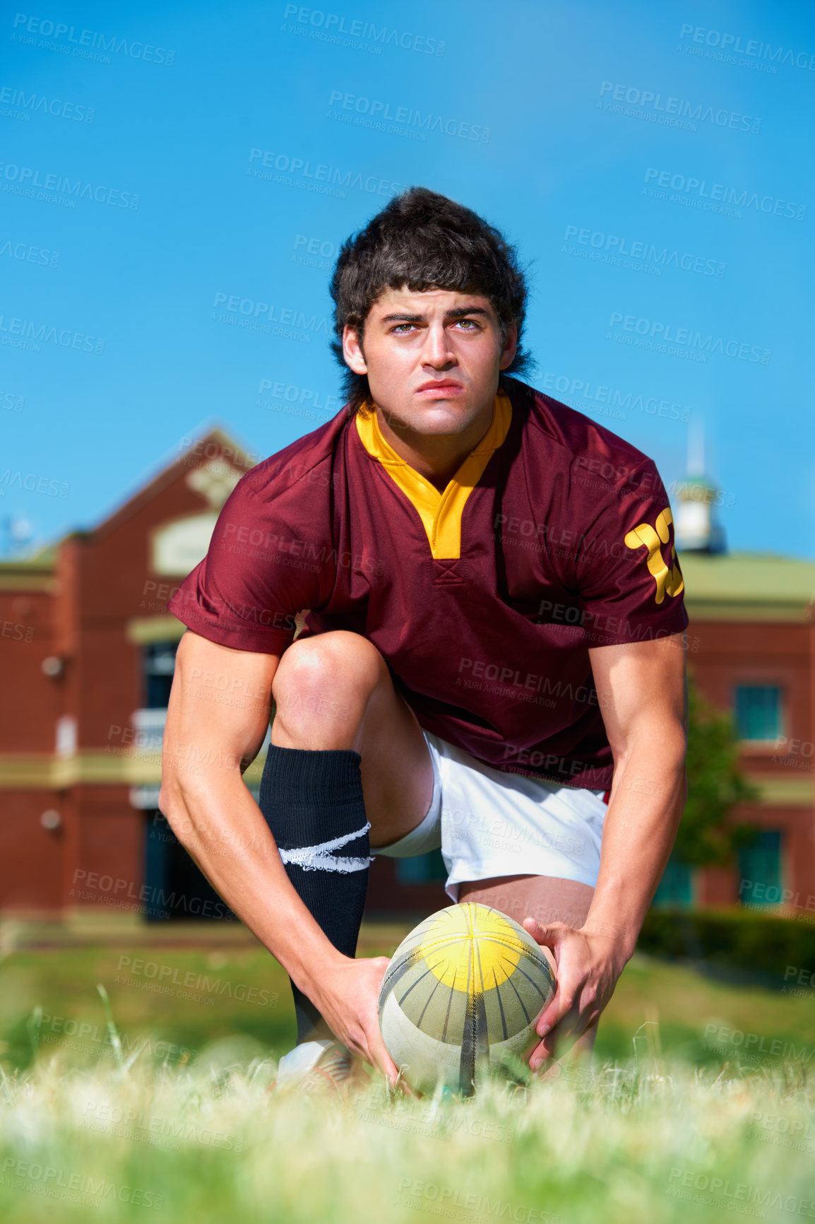 Buy stock photo Serious, man and rugby ball to prepare for match workout and exercise on a grass field. Body, strength and thinking male person or professional player in uniform ready to kick object for training 