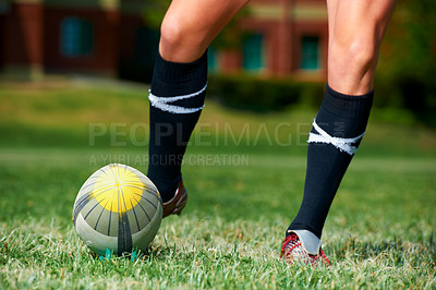 Buy stock photo Rugby, feet and man with a sports ball outdoor on a pitch for action, goal or score. Male athlete person playing in sport competition, game or start training for fitness, workout or kick exercise