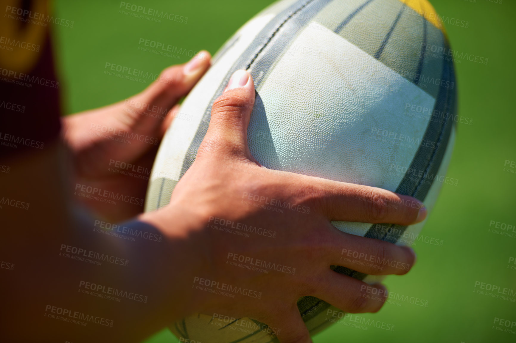 Buy stock photo Closeup shot a rugby player holding a ball