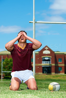 Buy stock photo Upset, sad and rugby player on a field for competition loss for training and match. Fit, athlete and sports with man and ball for mistake or fail in competitive looking frustrated in a uniform
