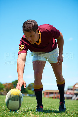 Buy stock photo Ready, prepare and male rugby player with a ball to kick on a green field for athletic workout. Sports, fitness and body in a uniform for training exercise and outdoors for active competitive game