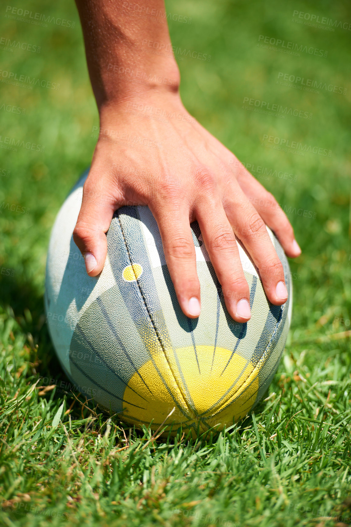 Buy stock photo Closeup, rugby and leg with a ball of a player to kick for fitness training on a grass field. Man, uniform and sports exercise for healthy green lawn and active athlete playing for health 