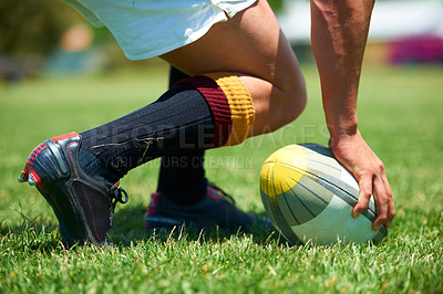 Buy stock photo Hand, rugby and ball with a sports man playing a game on a grass field for competition or recreation. Fitness, training and health with a male athlete getting ready to play a match outdoor in summer