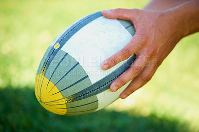 Buy stock photo Sports, rugby and ball in hands of person on field for training, competition and practice. Fitness, game and performance with closeup of athlete in outdoor pitch for challenge, score and health