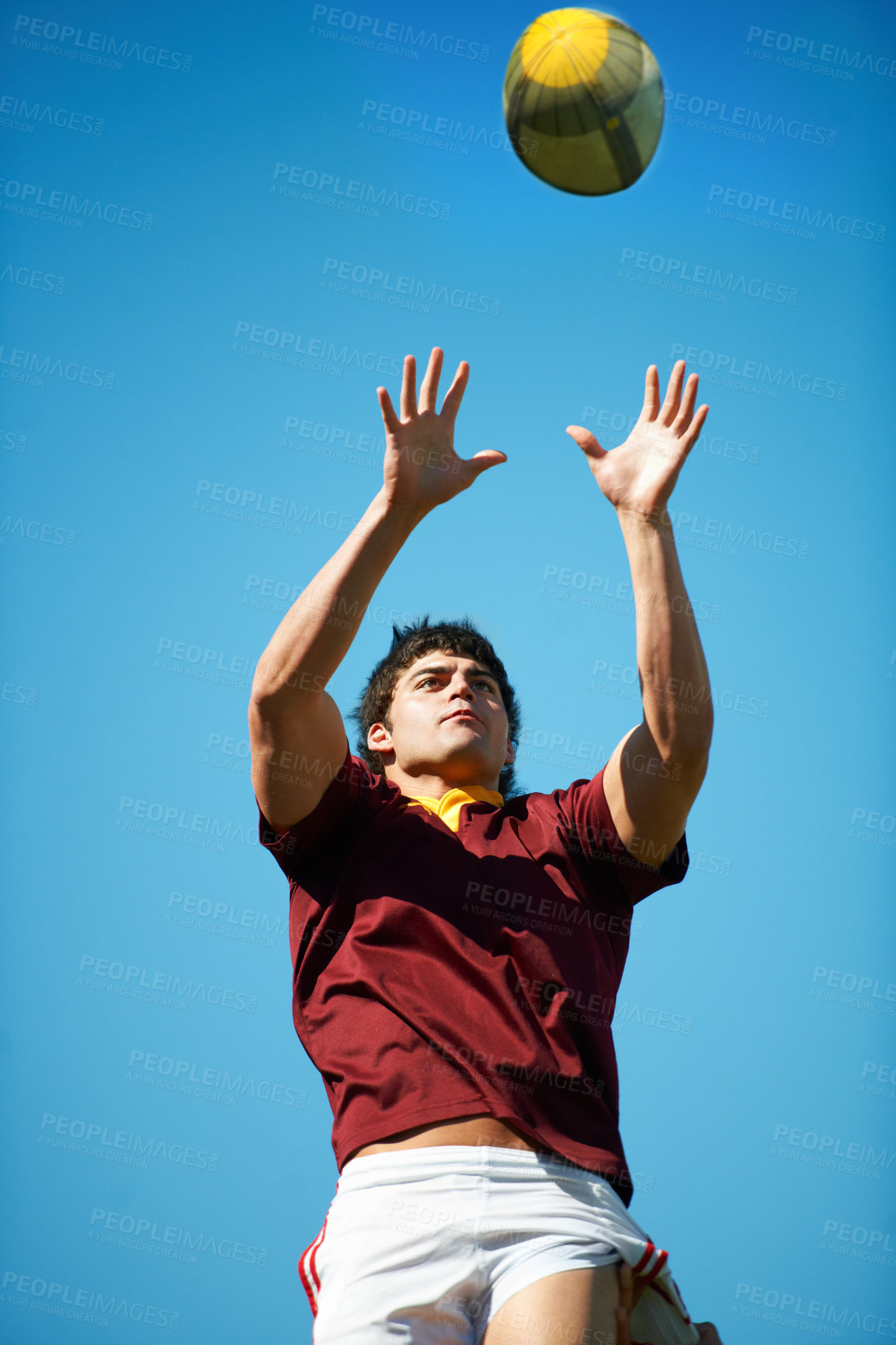 Buy stock photo Athlete, ball and rugby player catching in training on a blue sky background for sport. Professional male person, uniform and confident fit exercise or workout for game with a sportsman outdoors 