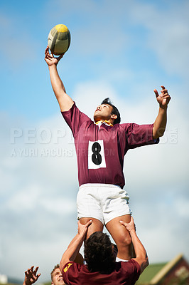 Buy stock photo Shot of a young rugby player catching the ball during a lineout