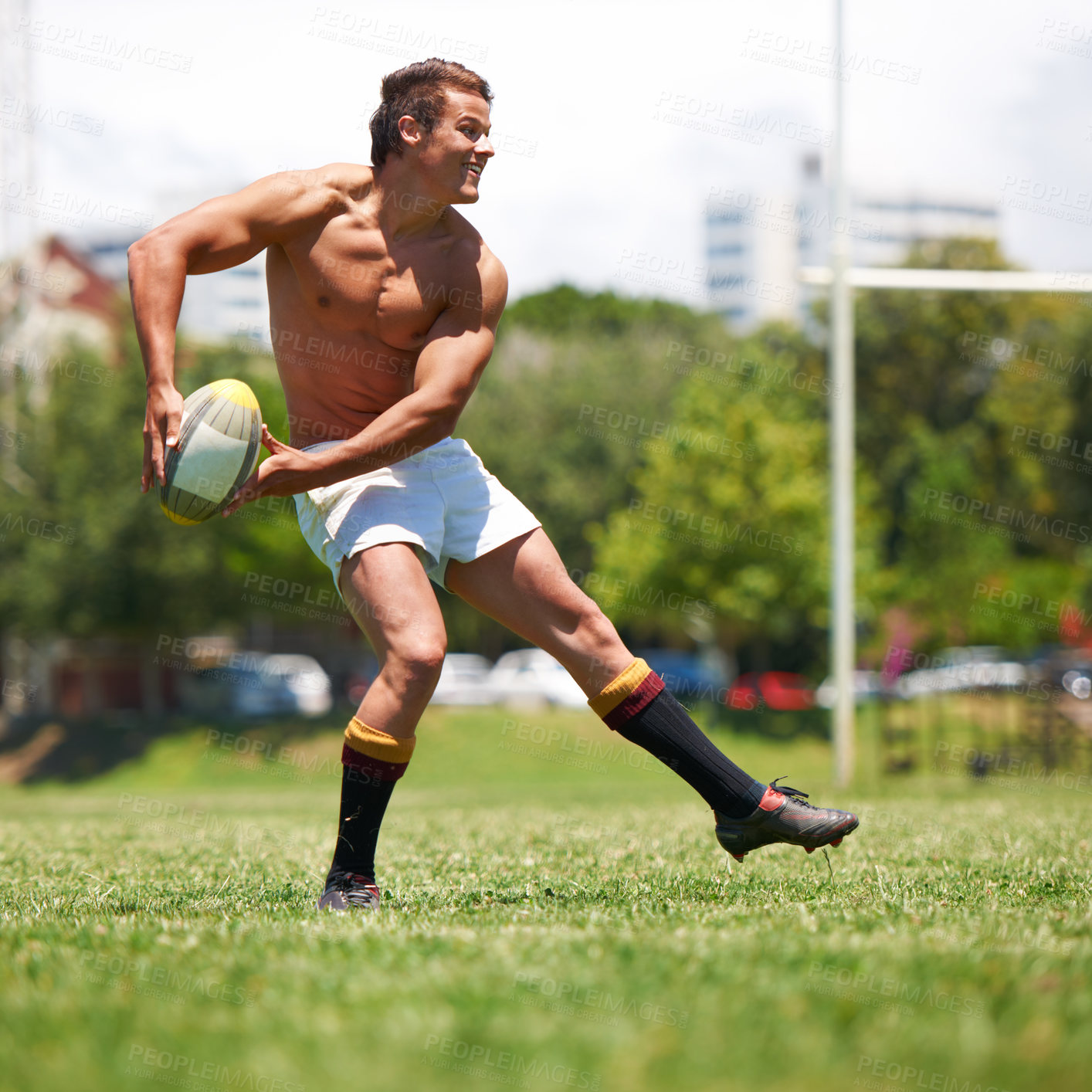 Buy stock photo Sports, rugby ball and fitness man on field for training, wellness and morning cardio outdoor. Handball, exercise or happy topless guy player running at stadium for competition, action or performance