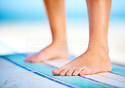 Buy stock photo A close up of feet on a surfboard on the beach