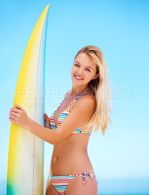 Buy stock photo Portrait of a surfer girl in her bikini holding on to her surfboard
