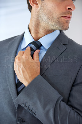 Buy stock photo Job opportunity, tie and a business man getting ready for work in studio on a white background. Corporate, company and dressing with a young employee adjusting his outfit for a professional career
