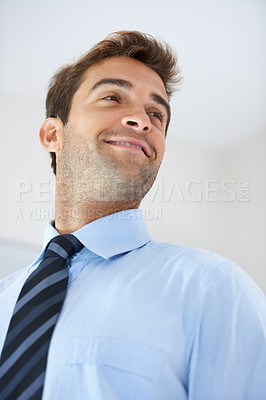 Buy stock photo Face, smile or thinking with a business man with a tie in studio on a white background from below. Vision, idea and planning with a happy young employee looking to the future while in his office