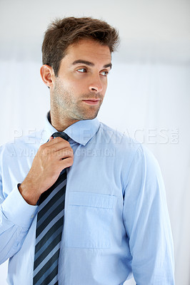 Buy stock photo Job opportunity, tie and a business person getting ready for work in studio on a white background. Corporate, company and dressing with a young man adjusting his outfit for a professional career