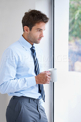 Buy stock photo Businessman, drinking coffee and exhausted at work, window and burnout at office, depressed and stress. Male person, reflection and thinking on career, tired and overworked or mental health issues