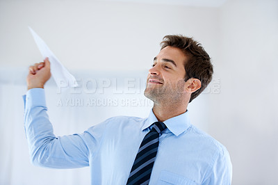 Buy stock photo Growth, paper plane and a happy business man in the workplace with a vision for the future of his career. Smile, fantasy and development with a confident young employee flying an airplane at work
