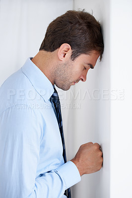 Buy stock photo Frustrated businessman, stress and mistake in anger, anxiety or burnout with fist on wall at office. Upset man or employee in financial crisis, depression or mental health problems at workplace