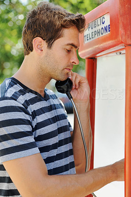 Buy stock photo Telephone, fashion and man in city by booth for communication, phone call and contact. Payphone, conversation and person in urban town for holiday, vacation and weekend in trendy clothes and style