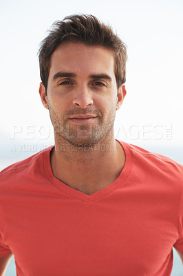 Buy stock photo Portrait of a handsome young man wearing a red t-shirt