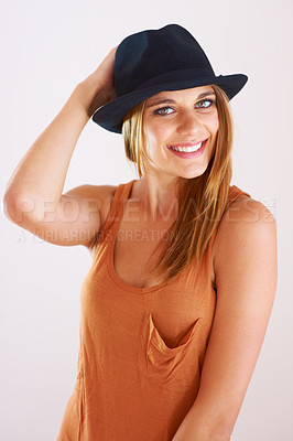 Buy stock photo A stylish young woman posing with a hat