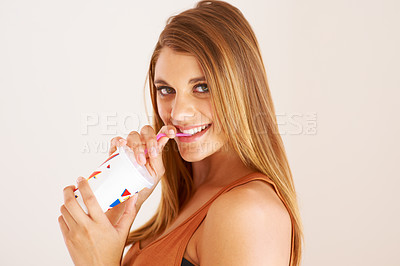 Buy stock photo A young woman drinking a soda for happiness, studio and relax wellness on vacation. Model, smile and face with sip straw for fizzy pop, thirsty and sweet seltzer with teenager by white background
