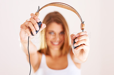 Buy stock photo Hands, portrait and happy woman with headphones in studio for listening, invitation or deal on white background. Music, offer and face of female model with subscription, streaming or radio earphones 