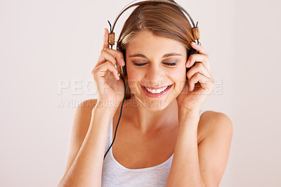 Buy stock photo Woman, music and smile with headphones in studio for freedom, audio subscription and streaming multimedia album on white background. Face of happy model listening to podcast, hearing sound and radio 