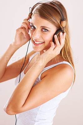 Buy stock photo Woman, portrait and smile with headphones in studio for music, audio subscription and streaming multimedia podcast on white background. Happy gen z model listening to album, hearing sound and radio 
