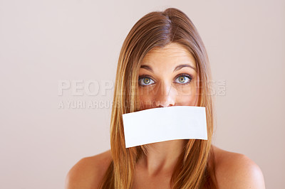 Buy stock photo Woman, mouth and sign for cover with mock up for silence in studio on white background. Portrait, female model and surprise in copy space for announcement, news or secret with placard, sign or poster