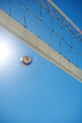 Buy stock photo Shot of a beach volleyball game on a sunny day