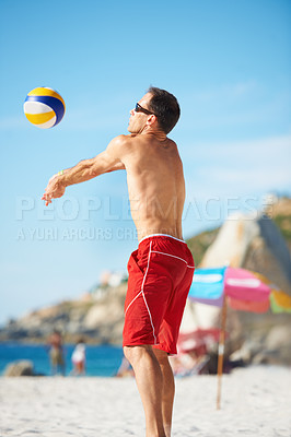 Buy stock photo Beach, volleyball and fitness man at sea with ball serve, energy or freedom on blue sky background. Ocean, sport or guy player with handball in nature for cardio, workout or athletic game performance