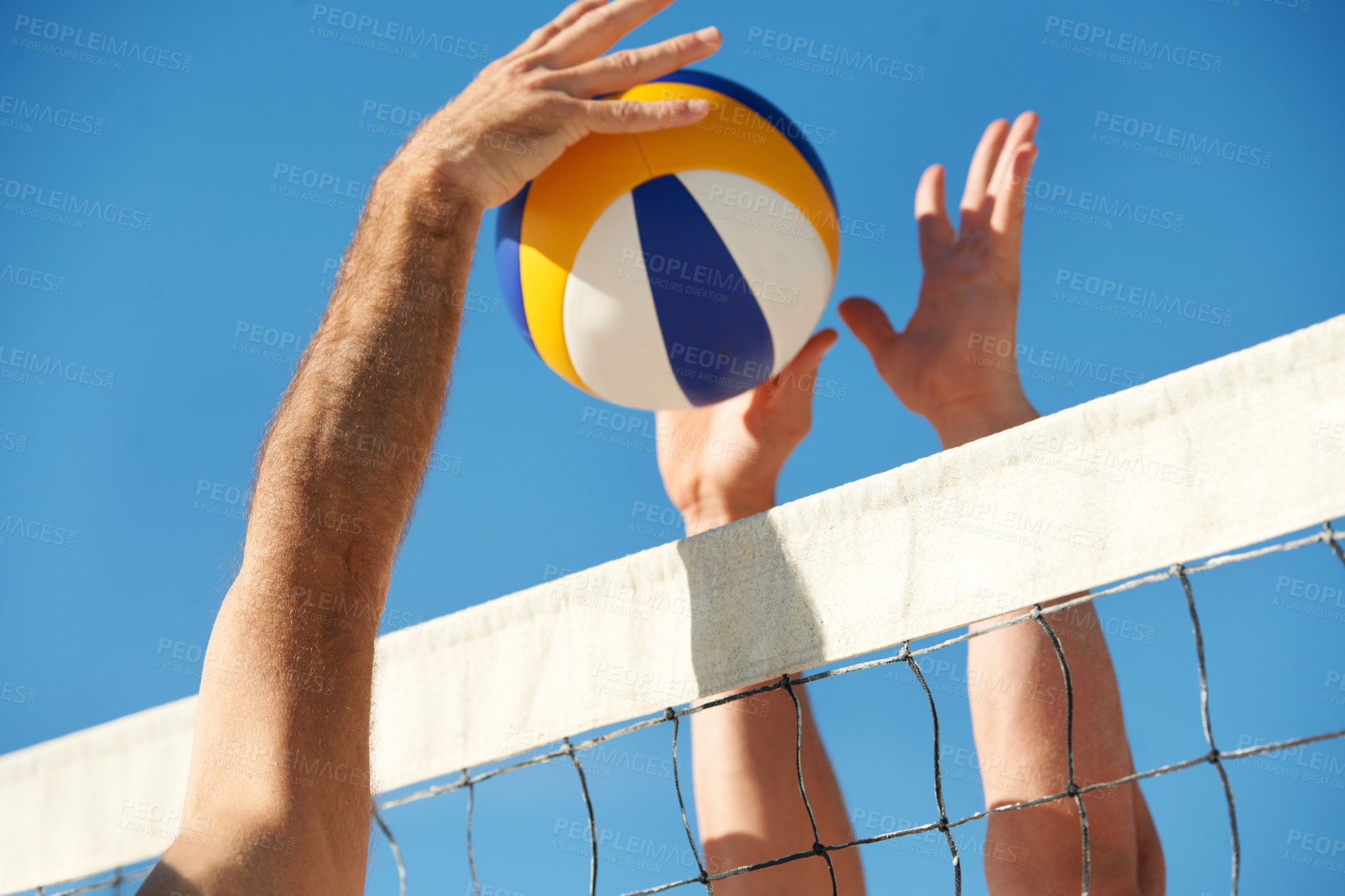 Buy stock photo Shot of a beach volleyball game on a sunny day