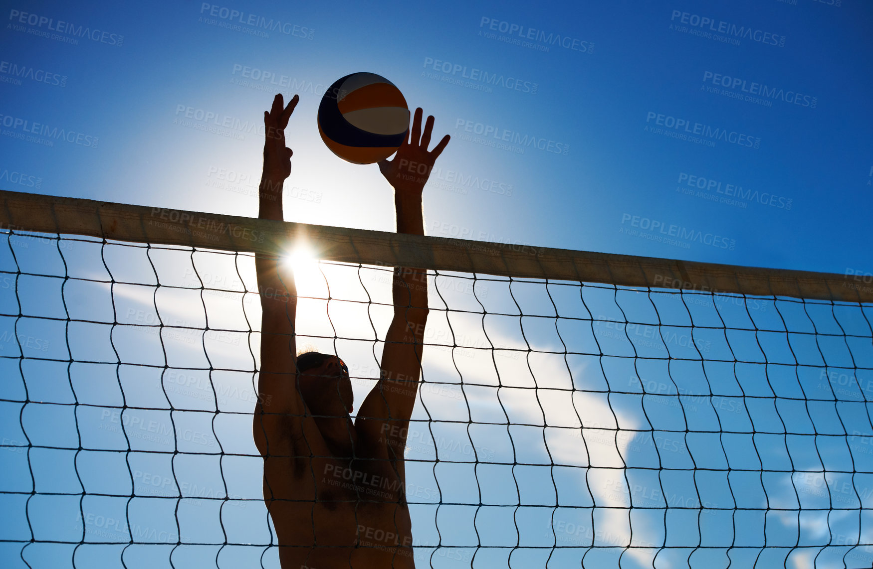 Buy stock photo Shot of a beach volleyball game on a sunny day