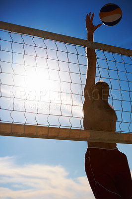 Buy stock photo Volleyball, jump and man at beach with ball serve, energy or freedom on blue sky background. Fitness, sports or male player with handball in nature for cardio, workout or athletic game performance