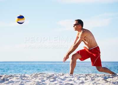 Buy stock photo Sports, volleyball and man at beach with ball serve, energy or freedom on blue sky background. Ocean, fitness or male player with handball in nature for cardio, workout or athletic game performance
