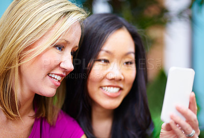 Buy stock photo Phone, gossip and friends on social media, internet and share meme in an outdoor park together chatting on an app. Technology, happy and young people or women search the web, website on a smartphone