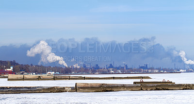 Buy stock photo Shot of industrial buildings along the waters edge