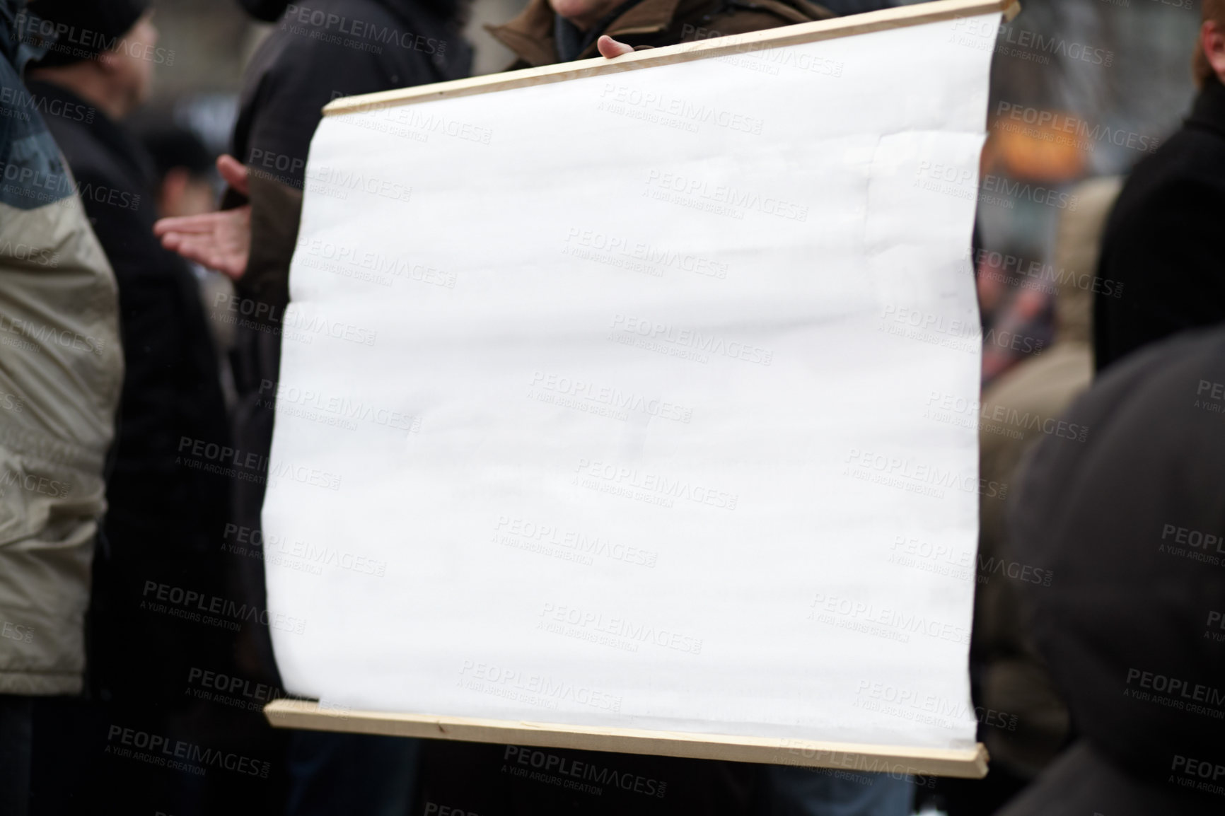 Buy stock photo An angry crowd protesting outside a public building